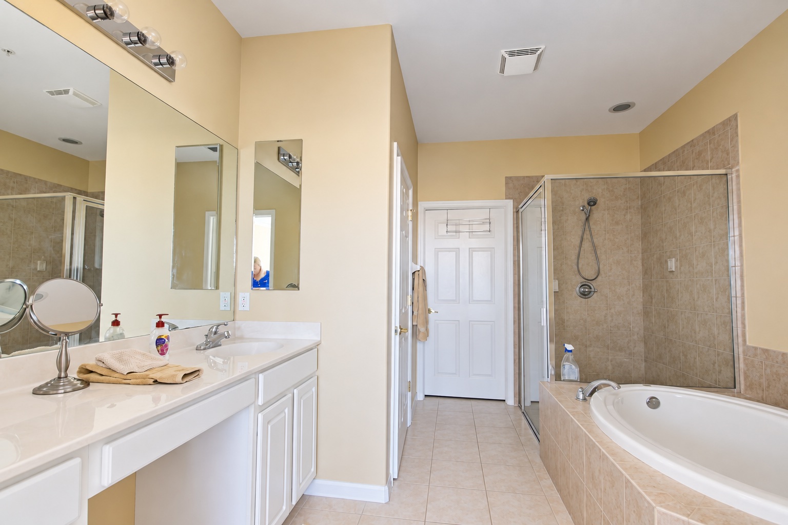 Master bathroom with double vanity, walk-in shower and corner tub