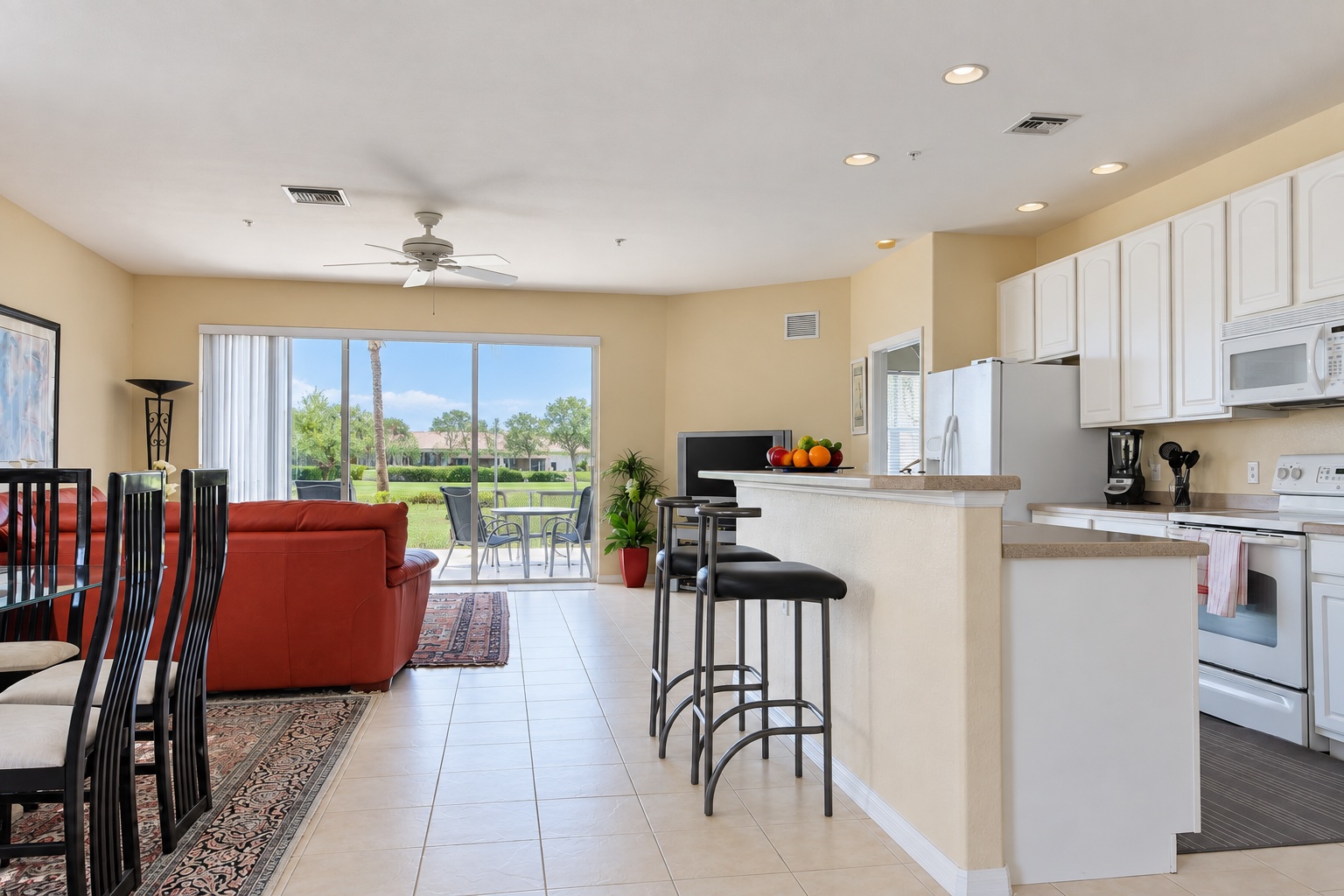 View across the dining area, living room and kitchen towards the lanai