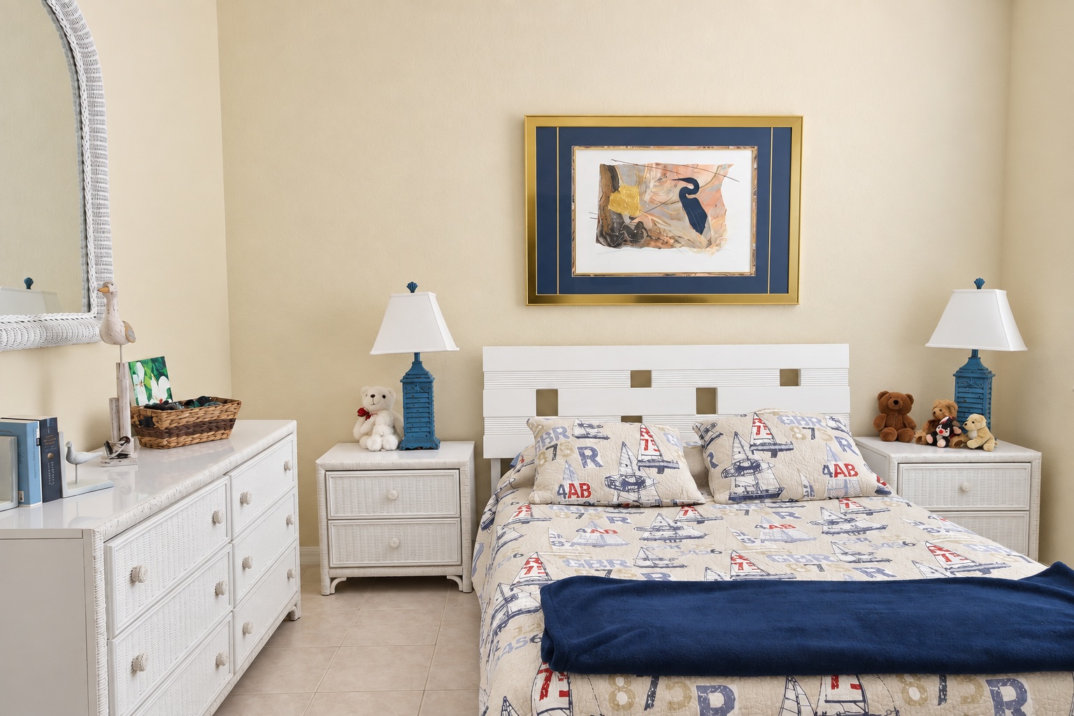 Guest bedroom with nautical bedding, dresser and blue lamps