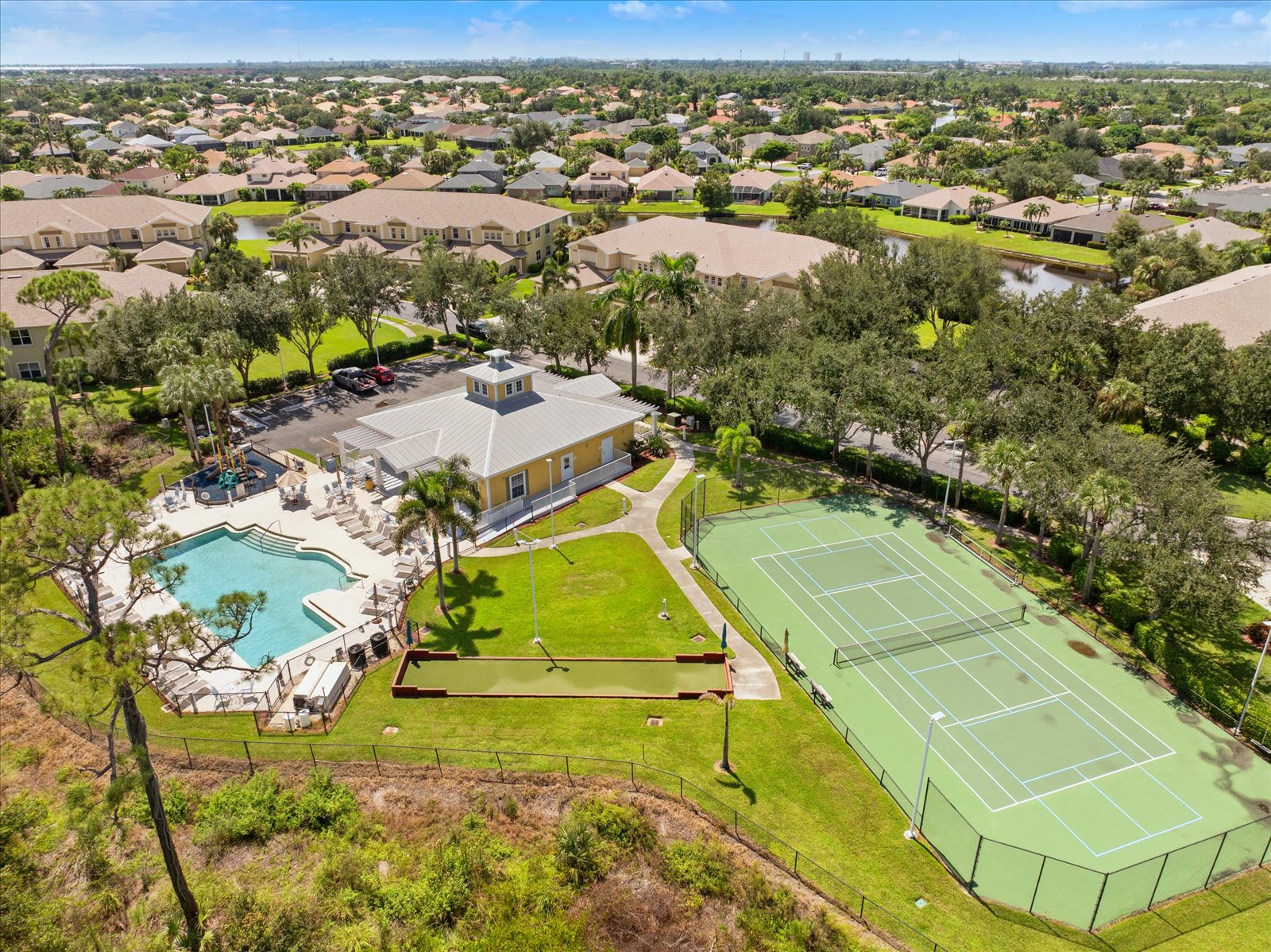 Aerial view of the community with clubhouse, pool, tennis and bocce courts